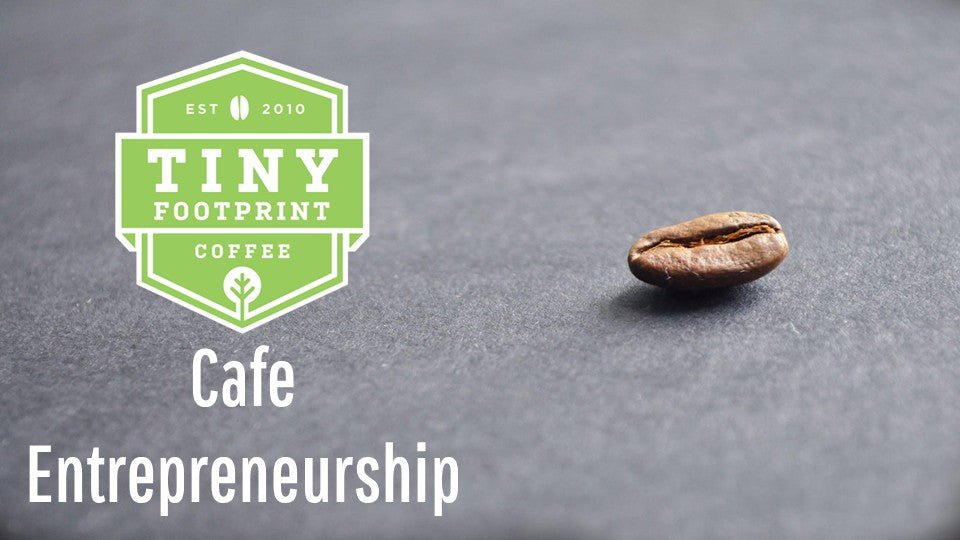 Tiny Footprint Coffee Cafe Entrepreneurship Banner - Green logo with on elegant coffee bean on a grey counter.